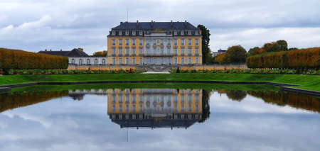 BrÃ¼hl Germany October 2019 rear view of Augustusburg Palace with parks and water reflectionのeditorial素材