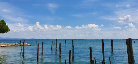 Sirmione Italy August 2021 View of Lake Garda and the mountains in beautiful weather with blue skyの写真素材