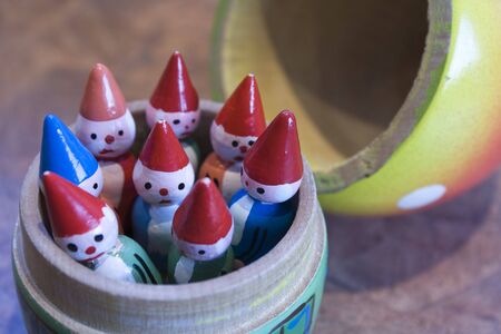 Painted wooden toy elves in a containerの写真素材