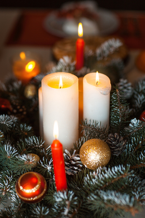 Candles in the decoration of fir branches and toysの写真素材