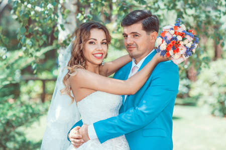 Summer wedding. Newlyweds are embracing and smilingの写真素材