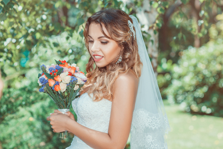 Portrait of a beautiful bride with a bouquet close upの写真素材