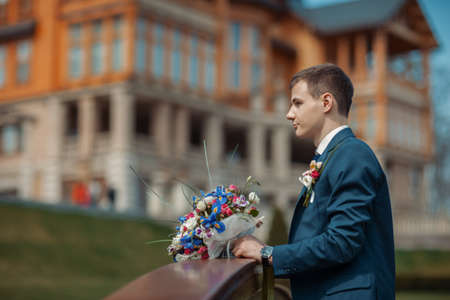 Portrait of a groom with a wedding bouquetの写真素材