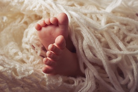 Legs of a young child wrapped in a blanket