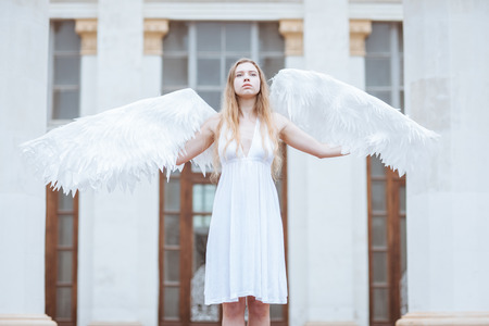 Beautiful angel girl spread her white wingsの写真素材