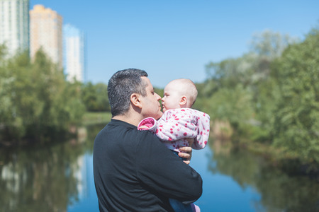 Father holding and hugging his little daughterの写真素材