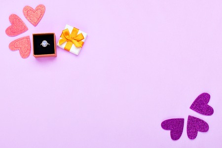 Decorations and gift box with a ring on a pink backgroundの写真素材