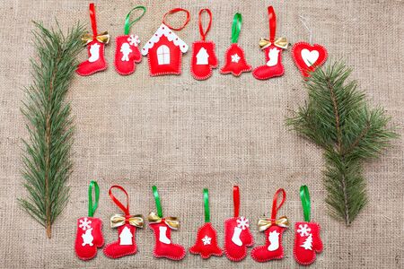 set of Christmas handmade decorations on a burlapの写真素材