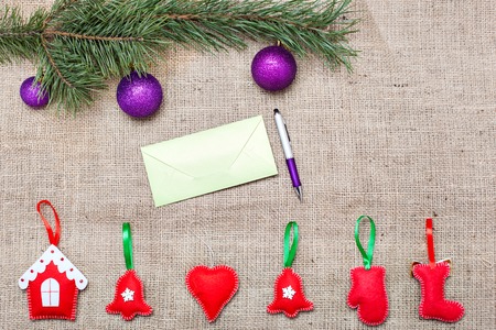 Christmas decorations and greeting card on a burlap backgroundの写真素材