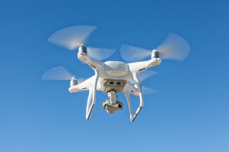 Copter with camera in the sky. Modern technology photo and video shooting.の写真素材