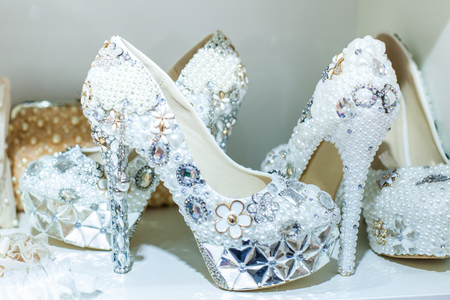 Bright wedding shoes are decorated with different precious stones and beadsの写真素材