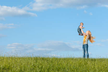 Mom on a walk with the baby. Mom throws baby upの写真素材