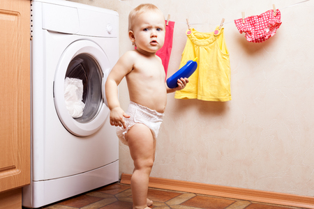 Little girl near a washing machineの写真素材