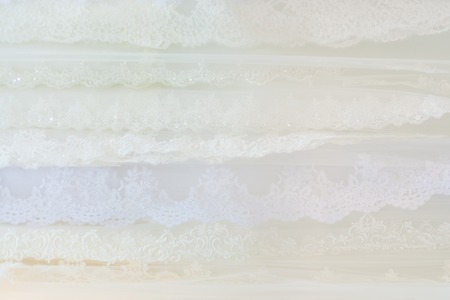 Shiny fabric is lying on a shelf in a storeの写真素材