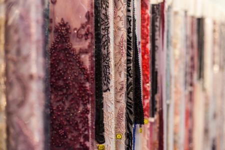 Many beautiful fabrics hang in the storefrontの写真素材