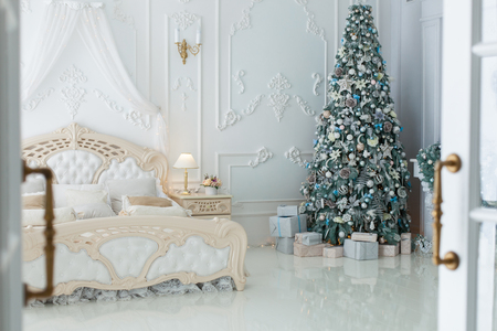 Christmas tree and gifts in the room in the style of rococo.の写真素材