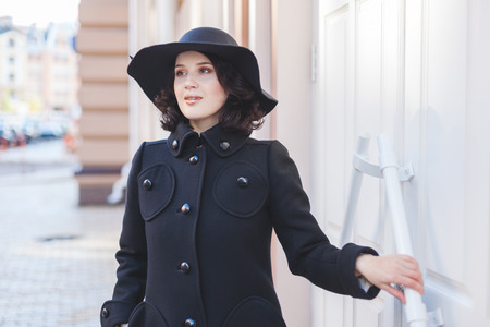 Portrait of cheerful full young woman in coat and hat.の写真素材