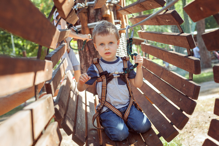 Little boy on an obstacle in an extreme park.の写真素材