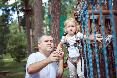 Dad helps his daughter overcome obstacles on the ride.の写真素材