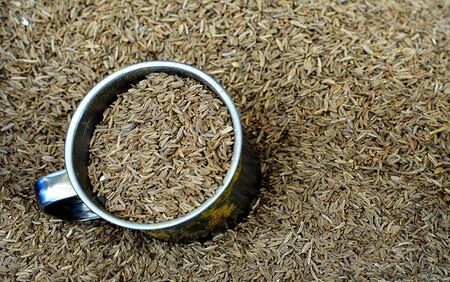 Cumin Caraway spice background with a cup at the Spice shop