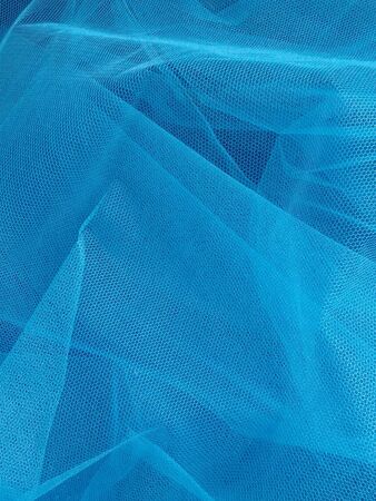 Beautiful blue background of transparent veil with several layers that create depth, airiness. Creative sky blue backdrop.の写真素材
