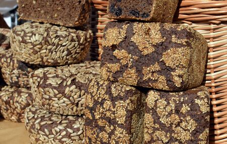 Types of Russian dark brown rye bread with sunflower seeds and raisins freshly baked and exposed at...