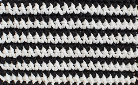 Black and white horizontal stripes - crocheted texture background, concept of contrast in life, ups...