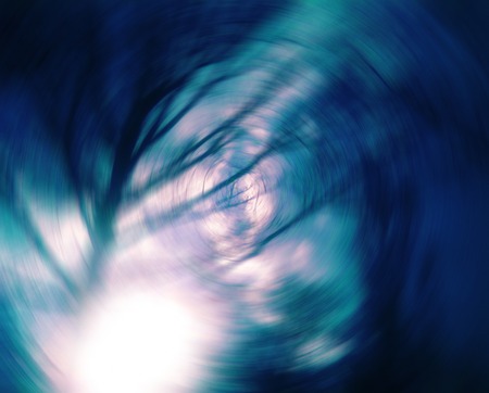 Radial blurred dark sunshine tree branch photo background.の写真素材