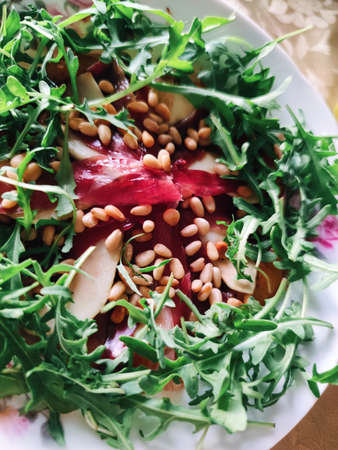 Fresh healthy arugula, prosciutto, pear, pine nuts salad restaurant delicious food macro photo.の写真素材