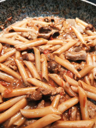 Tyrolean pork penne rigate feather pasta food pan photo.の写真素材