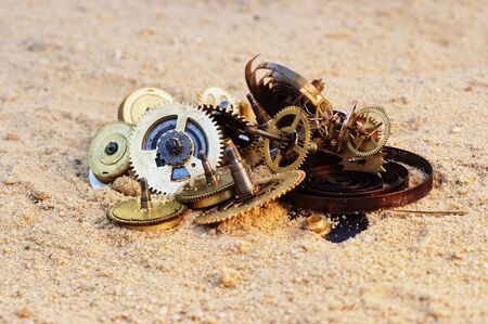 parts of clockwork mechanism on the sandの写真素材