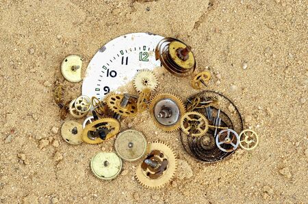 parts of clockwork mechanism on the sandの写真素材
