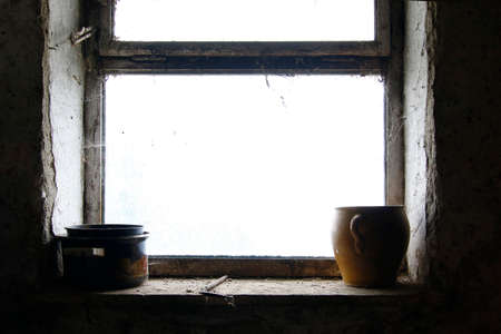 Old pots and stoneware jar on windowの写真素材