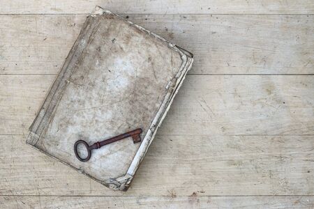 Detail of the rusty key on the old tattered bookの写真素材