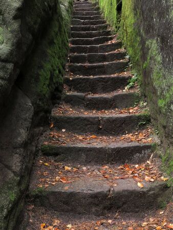 Old stone stairs carved in rockの写真素材