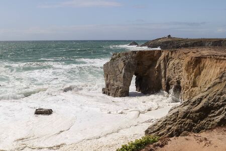 Spectacular cliffs and stone arch Arche de Port Blanc on famous coastline Cote Sauvage, Quiberon, Brittany (Bretagne), Franceの写真素材