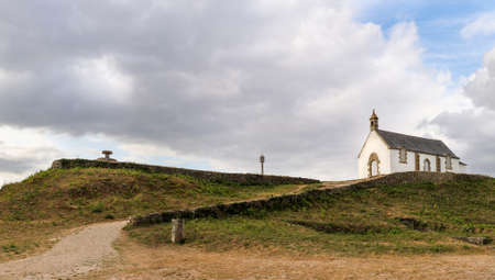 Megalithic grave mound Tumulus of St Michel with chapel of Saint Michel near Carnac in Brittany, France. It is the largest grave mound in Europe.の写真素材