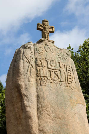Pleumeur-Bodou, France, August 9,2019: Menhir of Saint-Uzec. Menhir is about eight meters high and three meters wide. It is the largest menhir in France with Christian symbols. Pleumeur-Bodou, Brittany, France.のeditorial素材
