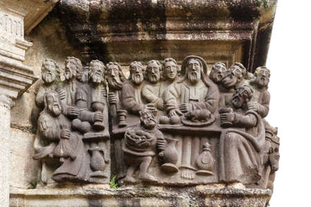 Guimiliau, France, August 8, 2019: Last Supper - detail of scene on the stone Calvary in Parish close Guimiliau, Brittany, Franceのeditorial素材
