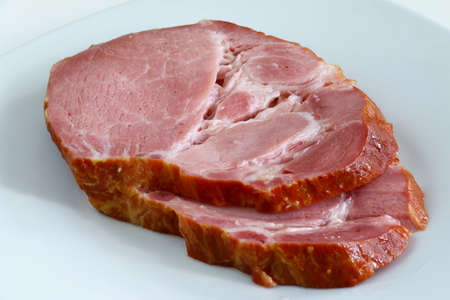 Two slices of smoked neck of pork on the plateの写真素材