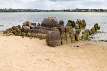 Neolithic tomb - dolmen or gallery grave also passage grave - of Guinirvit, ruins in the sea, Bay of Kernic, Plouescat, Finistere, Brittany, Franceの写真素材