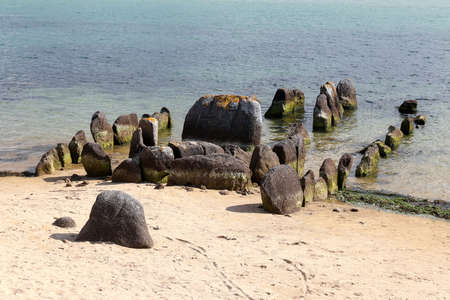 Neolithic tomb - dolmen or gallery grave also passage grave - of Guinirvit, ruins in the sea, Bay of Kernic, Plouescat, Finistere, Brittany, Franceの写真素材