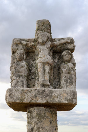 column of the crucifixion - detail of an old cross on the Saint-Michel tumulus near Carnac in Brittany, Franceの写真素材