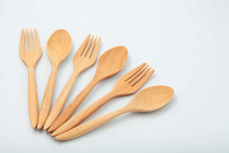 brown wooden spoons and fork on white backgroundの写真素材