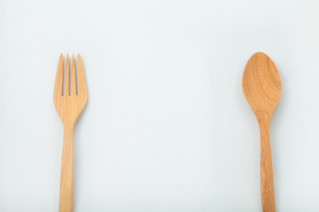 brown wooden spoons and fork on white backgroundの写真素材