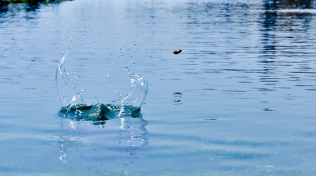 stone bouncing fast on the water surfaceの写真素材