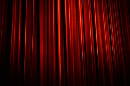 Beautiful red theater curtain with dark shadowsの写真素材