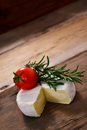 Italian tomino cheese on a wooden chopping board, italian appetizerの写真素材