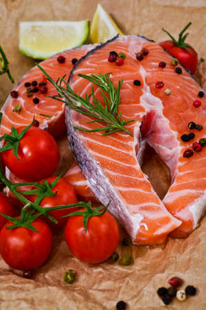 fresh salmon with rosemary, tomatoes, pepper and lemonの写真素材