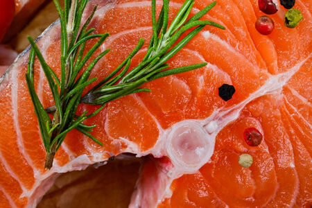 fresh salmon with rosemary, tomatoes, pepper and lemonの写真素材